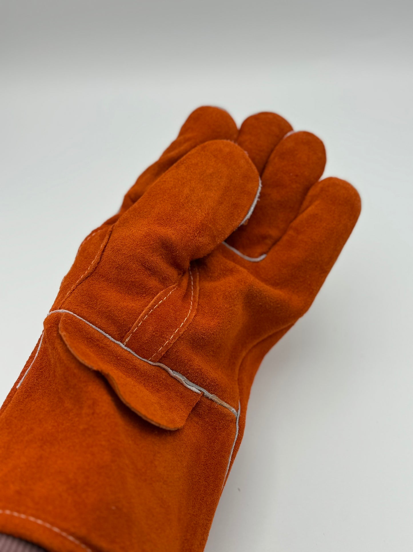 orange cowhide stick welding gloves on a white background