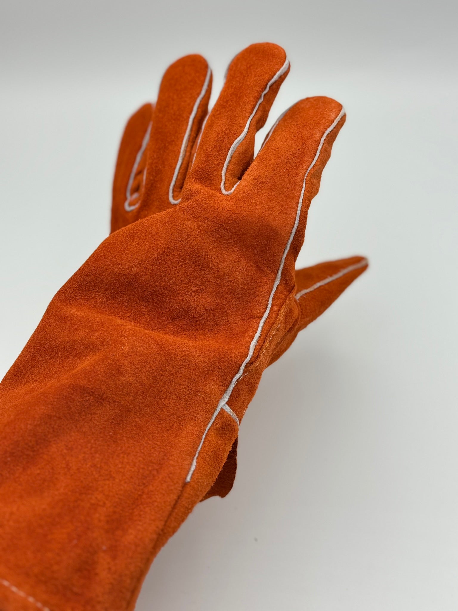 orange cowhide stick welding gloves on a white background