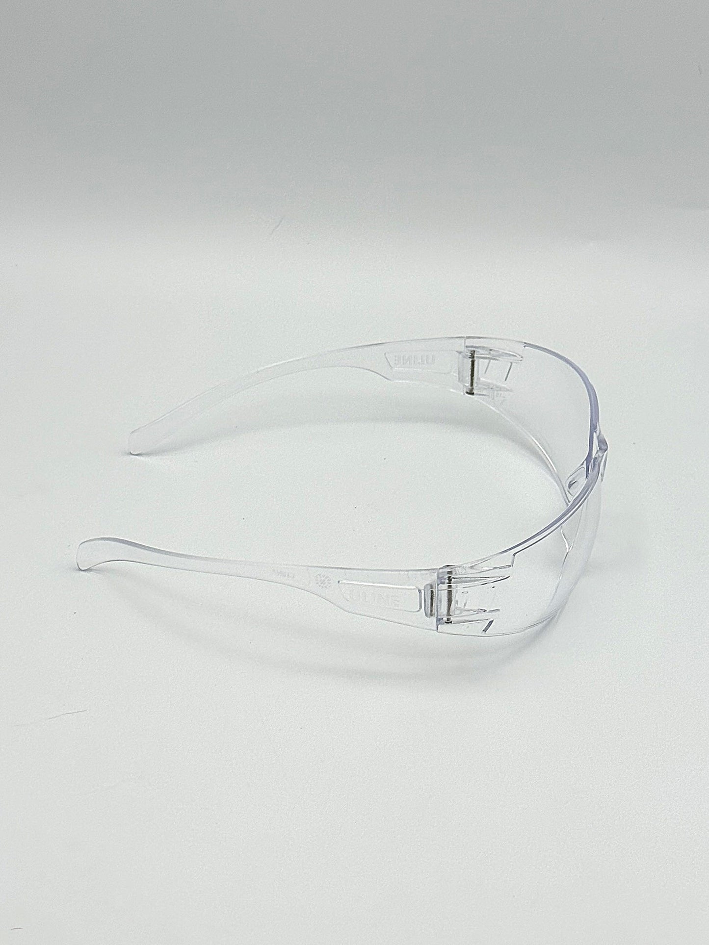 clear wrap around safety glasses on a white background