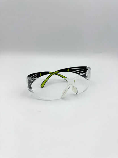 black and lime green side framed safety glasses with anti-fog clean lenses on a white background