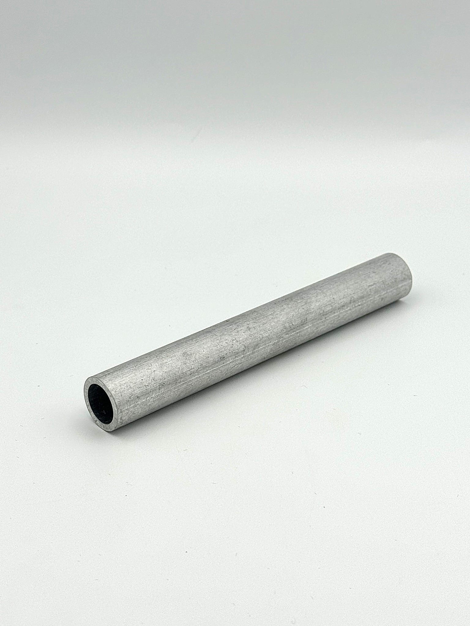 schedule 40 aluminum pipe piece on a white background